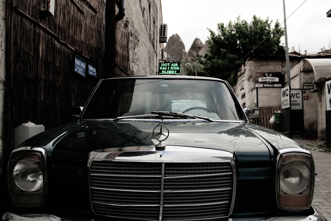 a-black-car-parked-on-the-side-of-a-street-noe3z-wi5hy